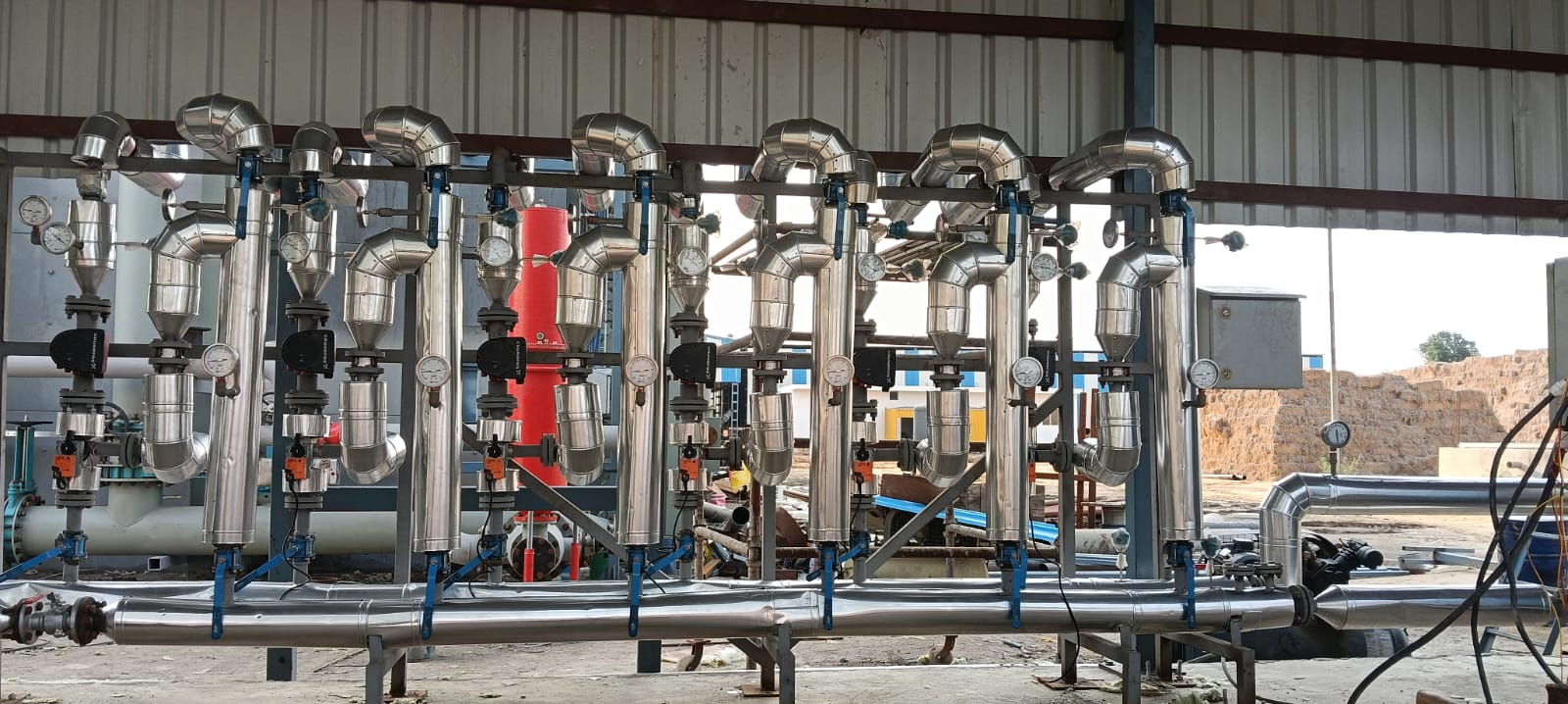 Insulated process heating pipework and valve manifold serving the digesters